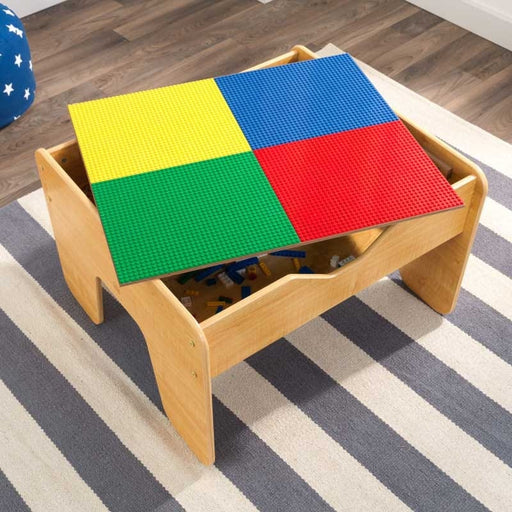 Top view image of opened playing surface in blue, green, red and yellow of 2 in 1 Lego Board and Table with room background