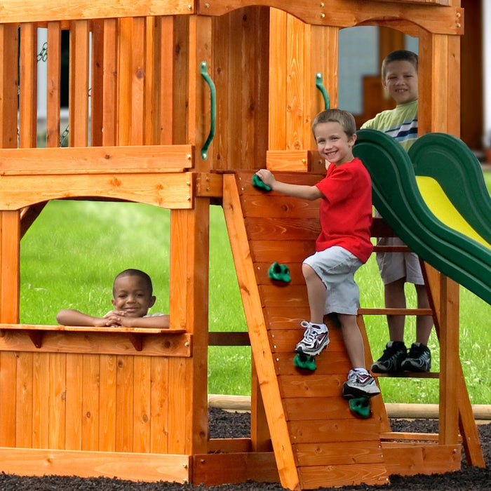 Image of 3 little boys, one is climbing the rock climbing wall, one climbing on the wooden ladder and on on the store of Backyard Discovery Atlantis Play Centre Swing And Play Set