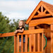 Close up image of a little girl standing on the balcony of Backyard Discovery Atlantis Play Centre Swing And Play Set