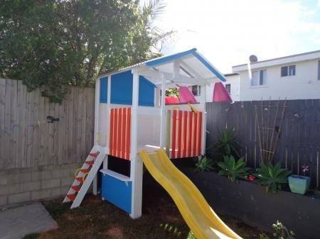 Medium Fort Cubby House - painted in white, orange and blue with yellow slide