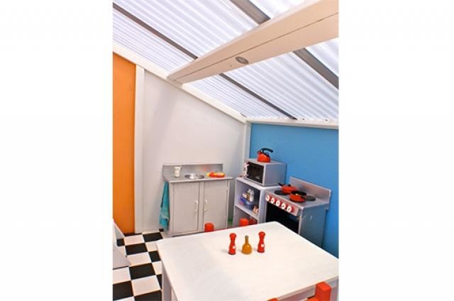Mega Triplex Cubby House - interior showing a kid's mini kitchen and white table