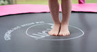 Close up of 4.5ft Junior Kids Trampoline Blue toddler trampoline flooring with Plum Logo and feet of a little child