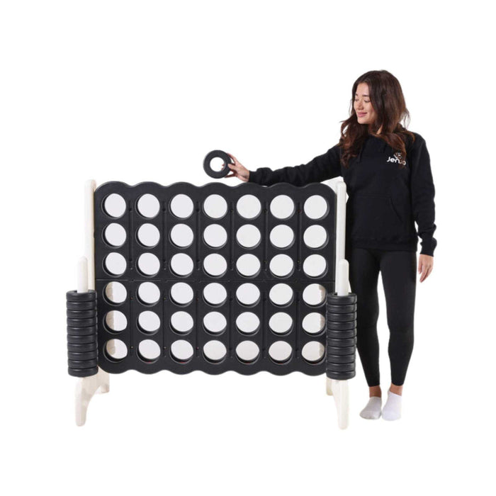 image of a lady standing next to the Giant 120cm connect 4 in Black and White