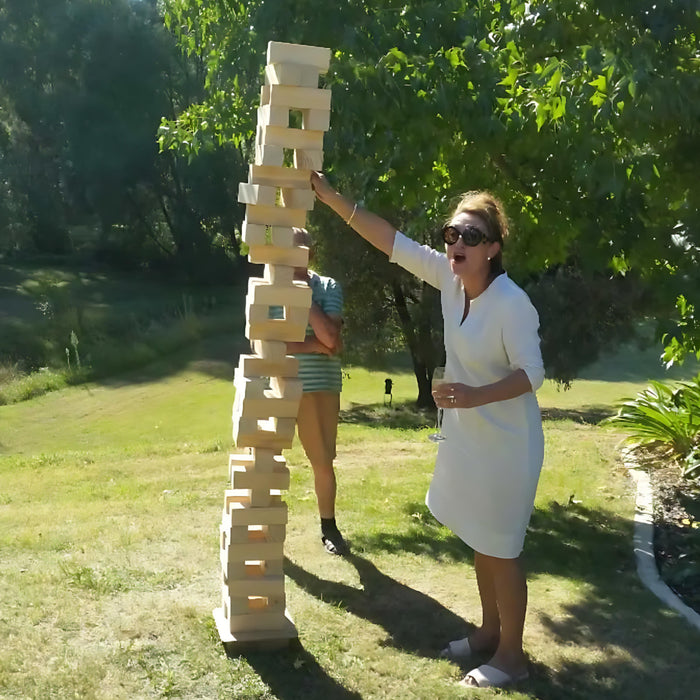 127cm giant jenga next to a person and it is falling