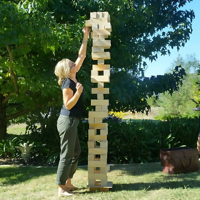 someone playing with a 127cm giant jenga