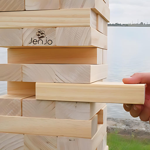 close up image of a hand taking a block out of the 63cm giant wooden jenga