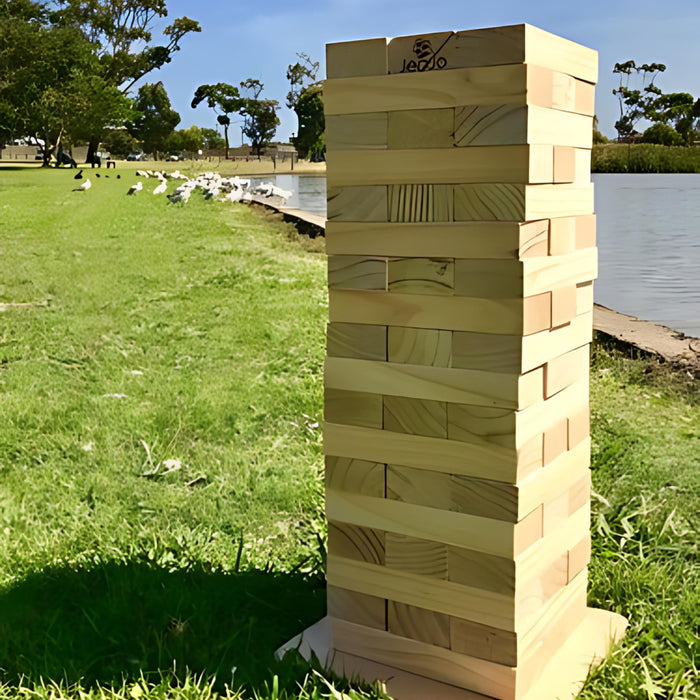 image of the 63cm giant wooden jenga with a pond and on grass as the background