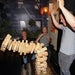 3 people who are playing giant jenga and it has collapsed in the air