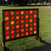 giant connect four outside ont the grass in the park 