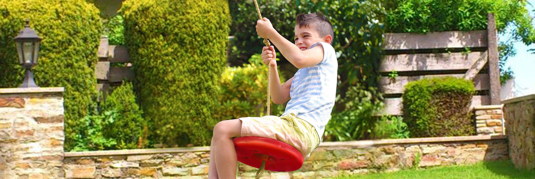 Lifestyle photo of a child on the Lifespan Kids Plastic Red Monkey Disc Swing