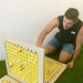 view of man playing giant battleship game on fake grass