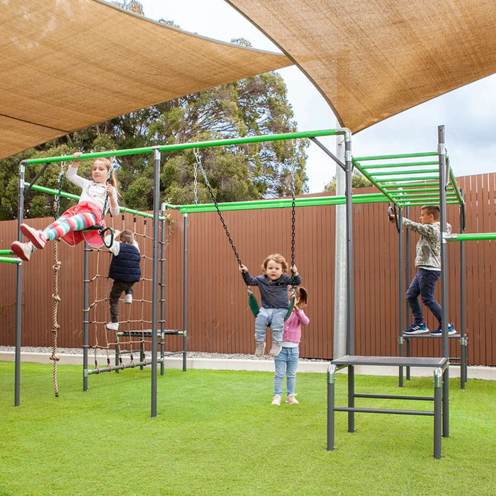 image of kids playing on the Junior Jungle Panama with a fence and  on fake grass