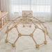 Wooden play structure in a nursery with toys and furniture.