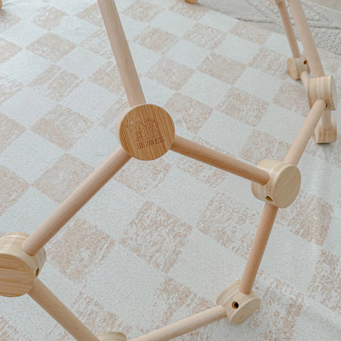 Wooden geometric toy on a checkered fabric background