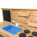 close up photo of the roma mud kitchen showing the stove sink and blackboard, two shelves plus two hooks with a white  backgorund