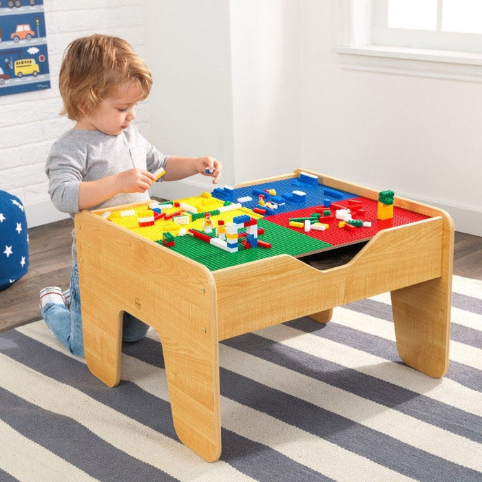 Full image of the playing surface of 2 in 1 Lego Board and Table with a little boy playing with legos on the table
