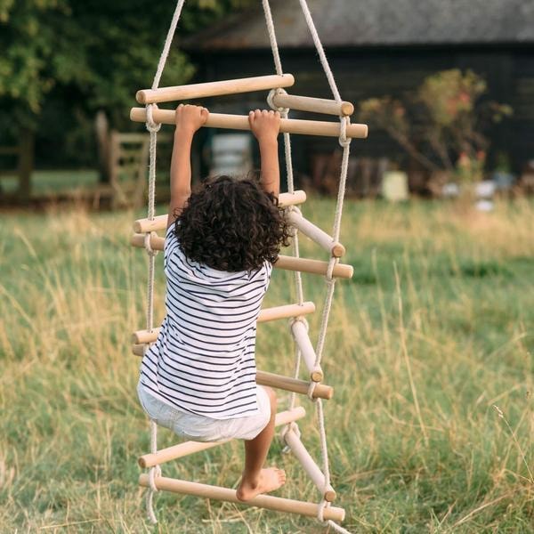 Full image of little kid climbing on the 3 Side Rope Ladder With Hangar with outdoor background