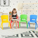 Image of a little girl sitting on the red chair of 4 Kids Plastic Chairs with white room background