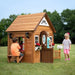 Image of kids playing in Aspen Cubby Playhouse with outdoor background
