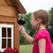 Close up of a little girl ringing the bell of Aspen Cubby Playhouse