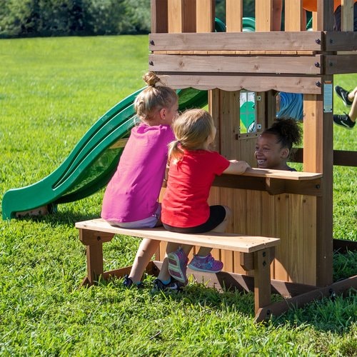 Close up image of 3 little girls playing on the snack shop of Lakewood Swing And Play Set in an outdoor background