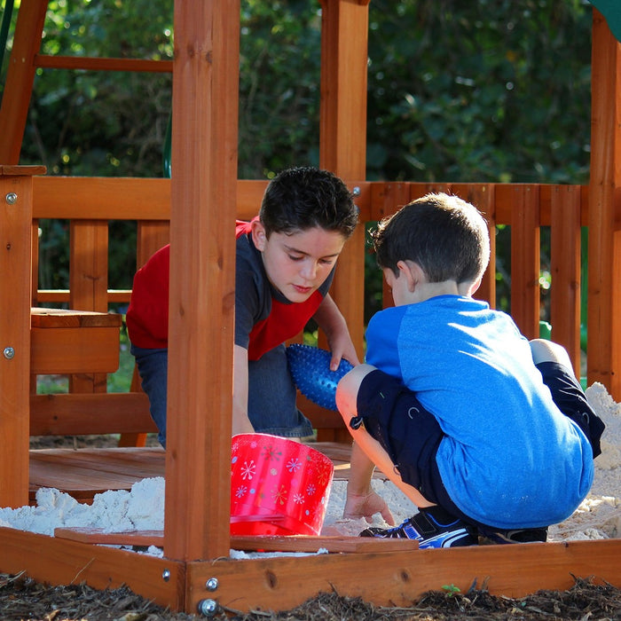 Close up image of 2 little boys playing on the sandpit of Skyfort II Swing And Play Set