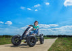 Image of a little kid riding the Berg BFR Black Go Kart with an outdoor background