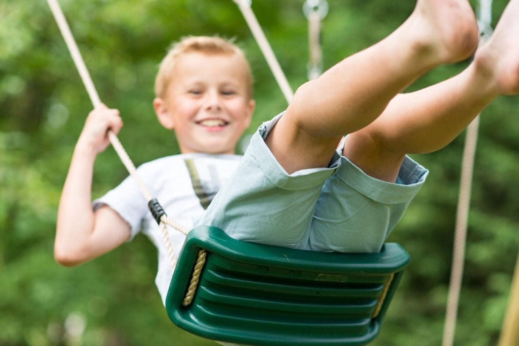 Double Wooden Swing Set - little boy swinging happily