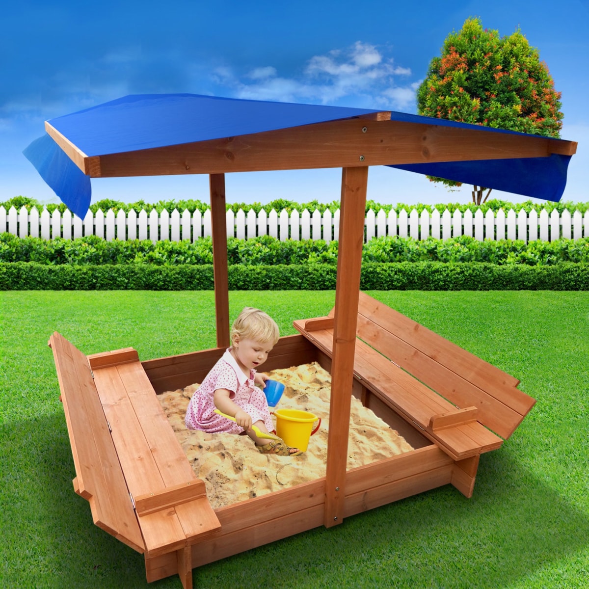 blue canopy sandpit with seats and cover, it has a white background and has a blue shade and child is sitting in the sandpit and playing with sand