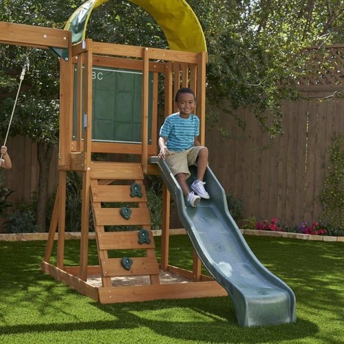Ainsley Climbing Playground - toddler sitting in slide