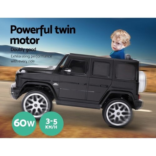 Side view image of Mercedes 12v AMG G63 with little boy riding on it showing the powerful twin motor of  the Mercedes 12v AMG G63