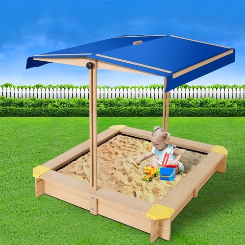 Image of a little girl playing inside the Sand pit with Canopy in outdoor background