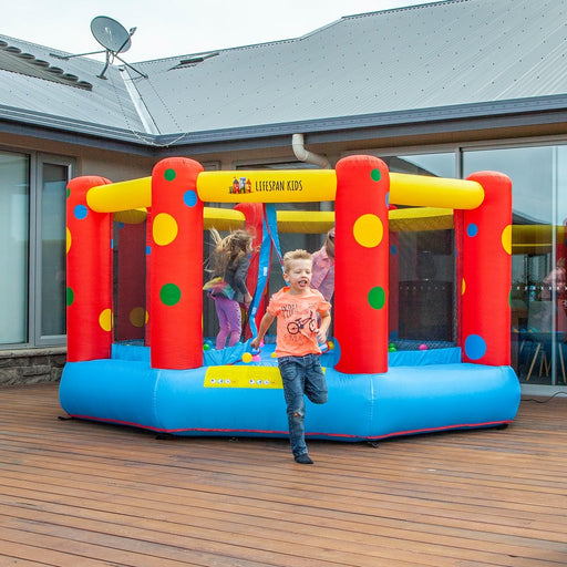 Full image of AirZone 8 12ft Jumping Bouncy Castle with  little children playing on the bouncy castle outdoor