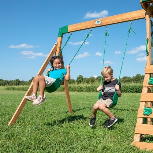 Close up image of 2 children swinging on the swing of Buckley Hill Play Set in outdoor background
