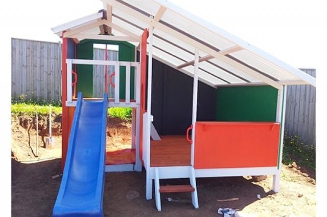 Mega Triplex Cubby House - empty house with blue slide; painted in green and orange