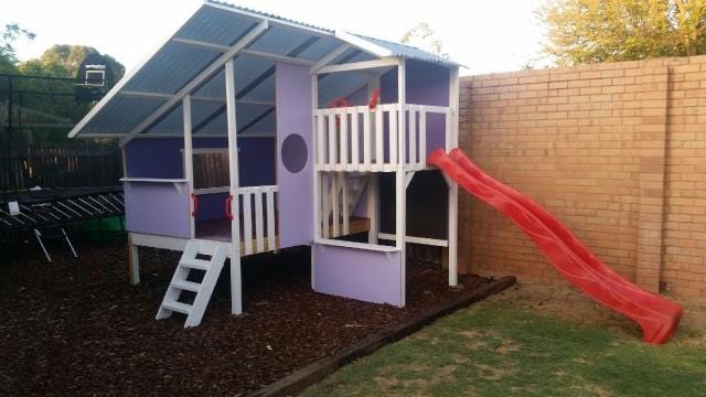 Mega Triplex Cubby House - woods as foundations painted in white while plywoods painted in blue and purple with red slide