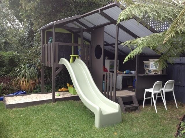 Mega Triplex Cubby House - painted in dark brown with white slide. fully furnished with sandpit and chairs