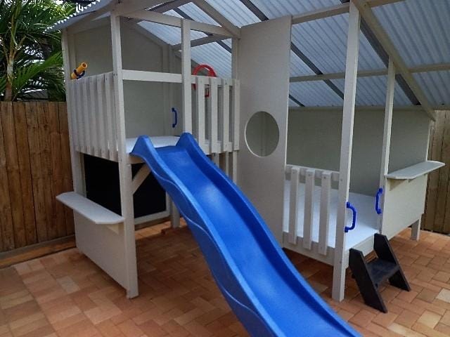 Mega Triplex Cubby House all white with black mini stairs and blue handles with blue slide