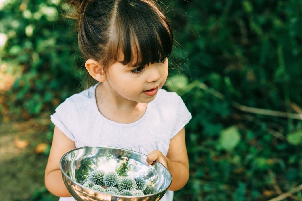 Child cooking at the Plum Discovery Mud Pie kitchen