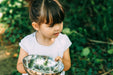 Child cooking at the Plum Discovery Mud Pie kitchen