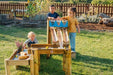 three kids playing with the forest water run on some grass