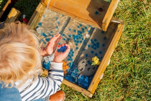 an above view of a child playing with the forest water run