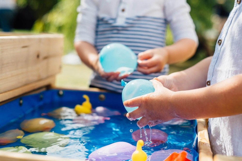 Sand And Water Table Bundle - kids playing water balloo\n