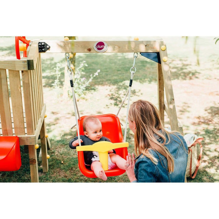 Close up image of a mom swinging her little boy on the baby seat of the Toddler Tower Outdoor Playset