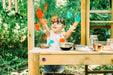 kid playing with the Mud Pie Wooden Kitchen features