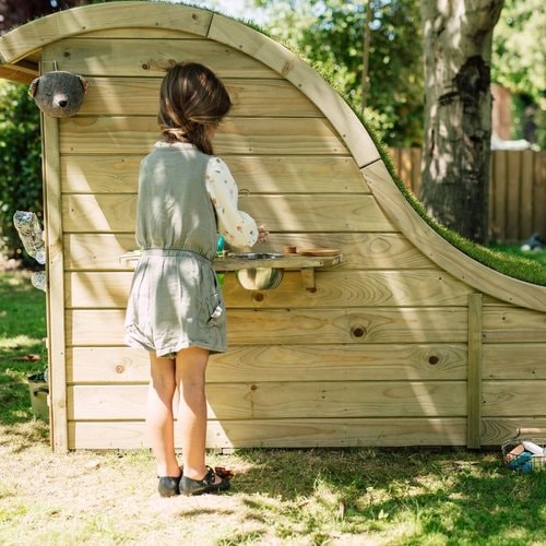 Nature Hideaway Cubby House - little girl preparing mud pie for snack