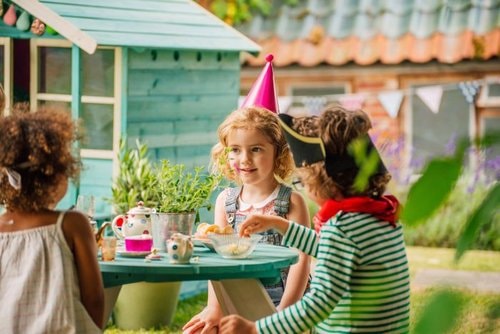 Plum Cubby House in Teal - little girls having tea