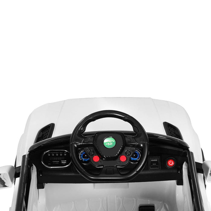 Close up image of dashboard; steering wheel with MP3 connectivity of Range Rover Kids Car in white background